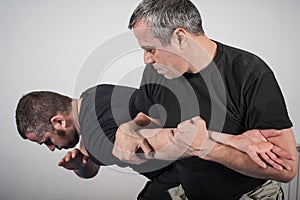 Kapap instructor demonstrates arm bar techniques