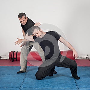 Kapap instructor demonstrates arm lock techniques