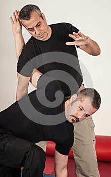 Kapap instructor demonstrates standing arm lock techniques