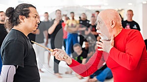 Kapap instructor shows knife techniques to large group of students