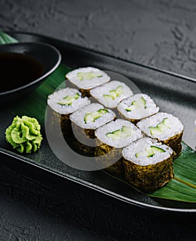 Kappamaki - cucumber sushi roll on black plate
