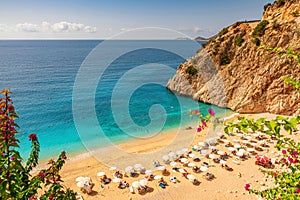 Kaputas beach with blue water on the coast of Antalya region in Turkey with sun umbrellas on the beach