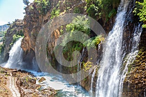 Kapuzbasi Waterfall in Aladaglar National Park Green trees round the waterfall soups composition.