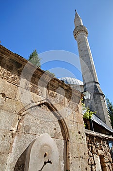 Karadoz Bey Mosque, located on Brace Fejica street, with a fountain and carvings in the foreground