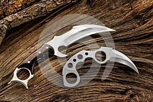 Karambit knives designer made, on the tree trunk