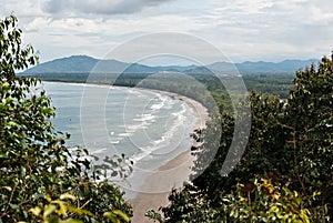 Karambunai beach shoreline seen from the peak of a hill.