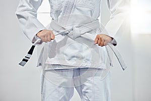 karate belt, martial arts and woman ready for fight battle, white dojo training or fitness challenge workout. Warrior