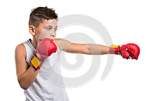 Karate boy in fighting stance, strikes with a hand, on his hands red gloves, on a white background