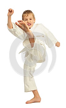 Karate boy kicking by left leg