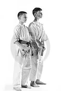 Karate boy in kimono fighting on a white background