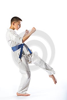 Karate boy in kimono fighting on a white background