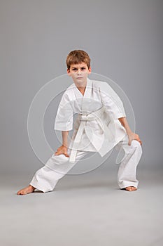 Karate boy in white kimono fighting