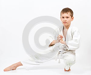 Karate boy in white kimono fighting