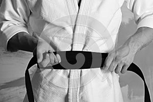 Karate fighter with fit strong hands gets ready to fight.