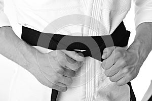 Karate fighter with fit strong hands gets ready to fight. Japanese karate and sports concept. Male torso and sportive