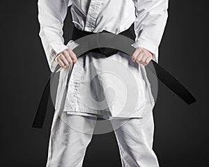 karate fighter proudly holding black belt. High quality beautiful photo concept