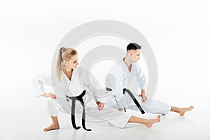 karate fighters stretching legs isolated