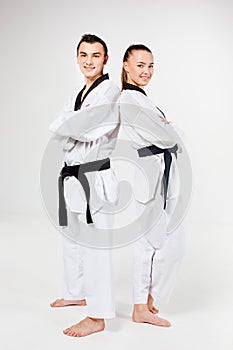 The karate girl and boy with black belts