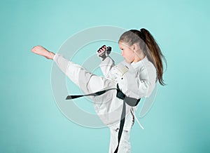 Karate gives feeling of confidence. Strong and confident kid. She is dangerous. Girl little child in white kimono with