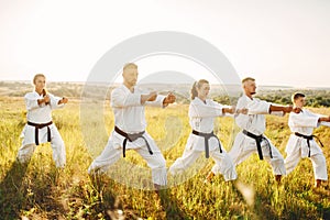 Karate group with master in white kimono