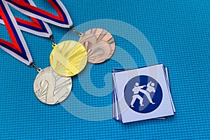 Karate Kumite icon and medal set, gold silver and bronze medal, blue background. Original wallpaper for summer olympic game in