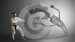 Karate man fighting with a big scary shadow