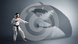 Karate man fighting with a big scary shadow
