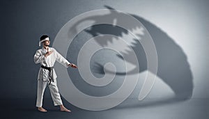 Karate man fighting with a big scary shadow