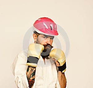 Karate man with serious face in golden boxing gloves