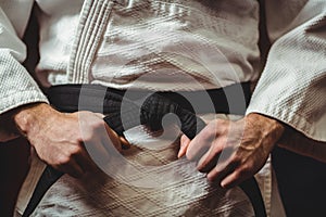 Karate player tying his belt