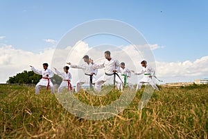 Karate School With Trainers And Boys Warming Up