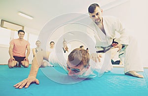 Karate teacher demonstrates techniques of receptions