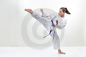 In karategi, a sportswoman strikes a kick photo