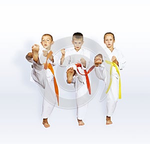 In karategi three athletes beats kick leg