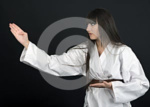 Karateka asian girl on black background studio shot