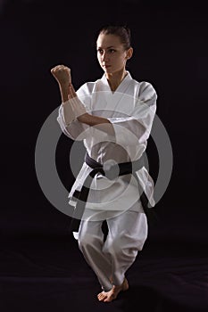 Karateka girl on black background