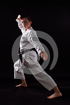 Karateka girl on black background photo