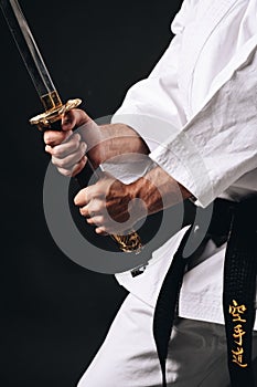 Karateka practicing kata with black background photo