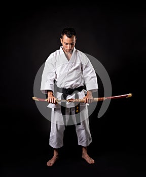 Karateka practicing kata with black background photo