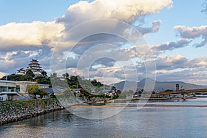 Karatsu japanese Castle Karatsu-jo Located on hill and blue sky with clouds at the side of matsuura river in evening, Karatsu,