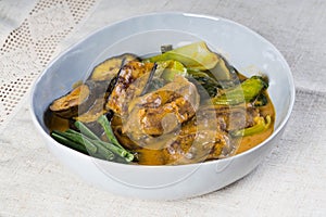 Kare kare; a mix of ox tail and tripe with vegetables like eggplant, sitaw long bean, pechay, puso ng saging stewed in peanut sa