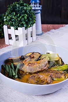 Kare kare; a mix of ox tail and tripe with vegetables like eggplant, sitaw long bean, pechay, puso ng saging stewed in peanut sa