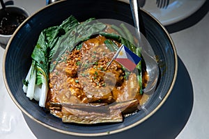 Kare-kare is a Philippine stew that features a thick savory peanut sauce.