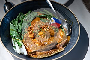 Kare-kare is a Philippine stew that features a thick savory peanut sauce.