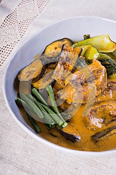 Kare kare; a mix of ox tail and tripe with vegetables like eggplant, sitaw long bean, pechay, puso ng saging stewed in peanut sa photo