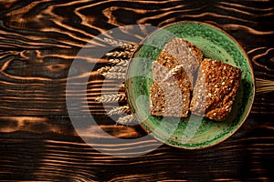 Karelian bread made from whole grain flour located and ears of rye or wheat grain. top view, space for text