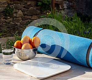 Karemat, tangerines, scales and glass of water