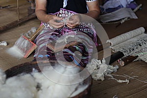 Karen woman pulling and taking out wool .