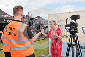 Karen Wright celebrity baker being interviewed by a film crew at Seaham Food Festival