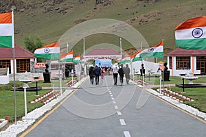 Indian tricolor national flag flying in front the Dwars memorial or Kargil War Memorial Tourist heading towards gate